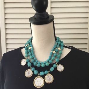 Multi strand necklace with Medallion details.